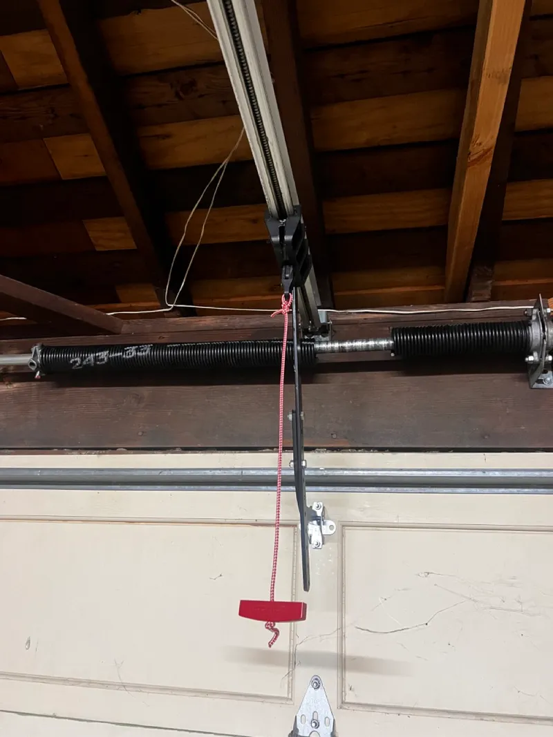 Technician replacing a garage door torsion spring